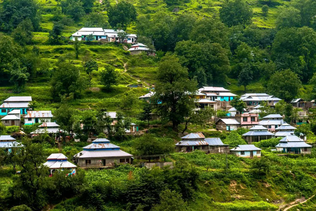 white and blue concrete house surrounded by green trees during daytime pakistan tourism