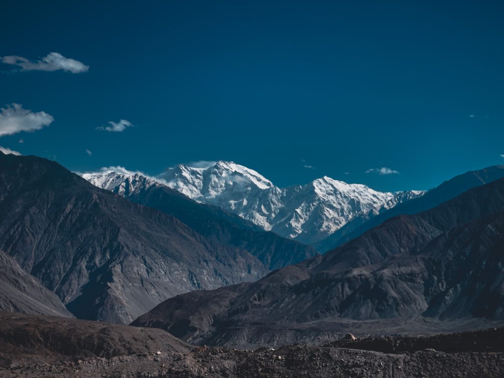 snow covered mountains under blue sky during daytime pakistan tourism