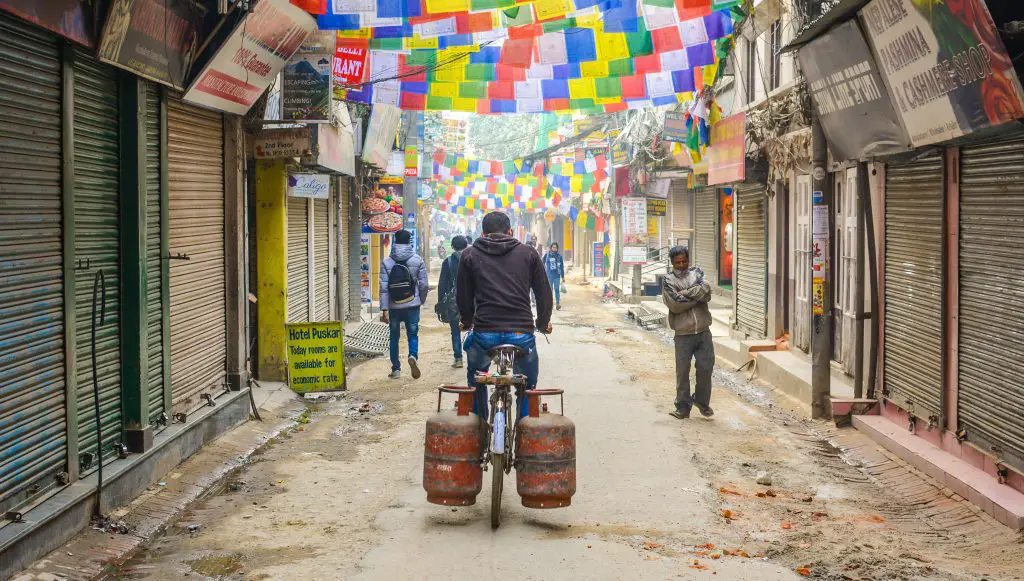 man riding bike with two gas cylinders