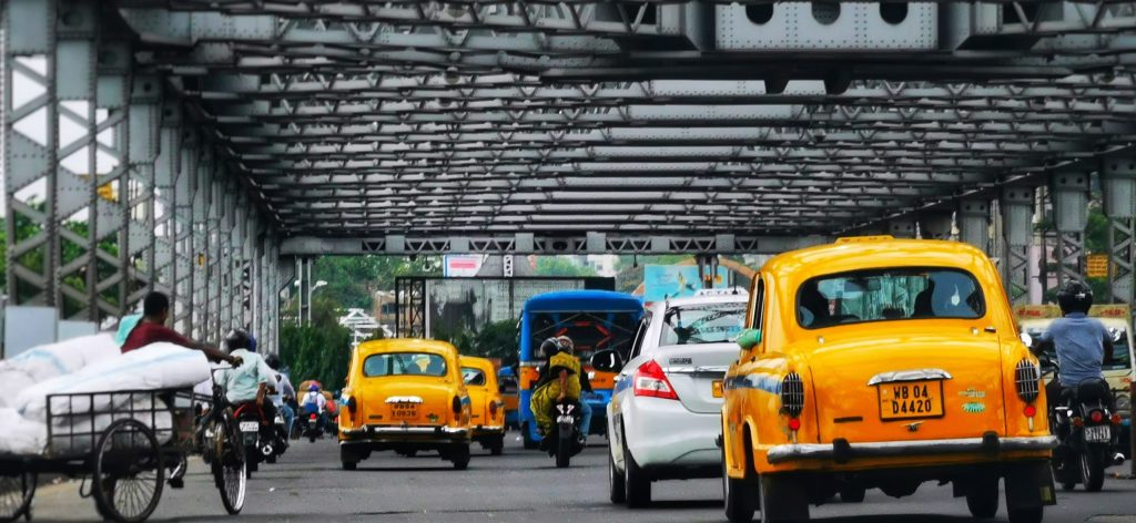 cars parked on the side of the road kolkata cities
