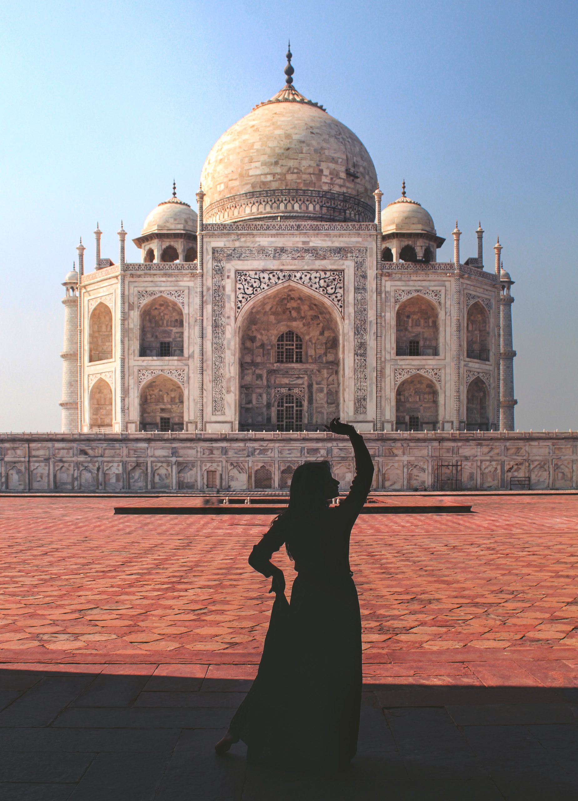 woman in black dress standing near white concrete building during daytime taj mahal tickets