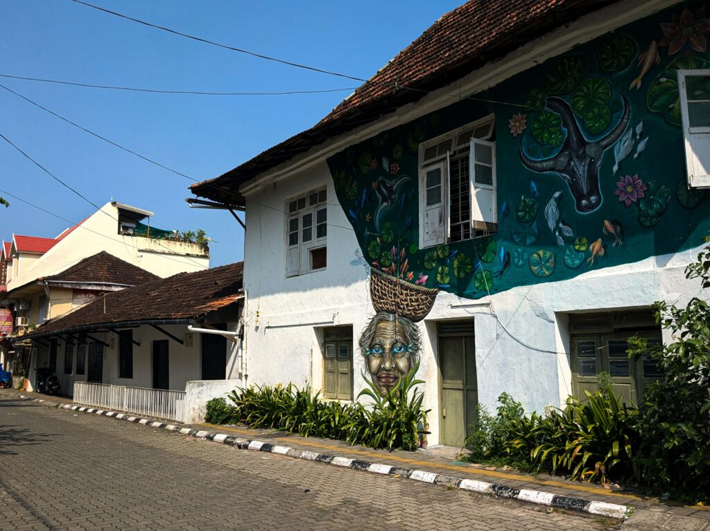 Colonial era stucco buildings and trees along Princess Street in Fort Kochi