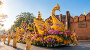 Elaborate floral float decorated with marigolds and orchids passing Thapae Gate in Chiang Mai.