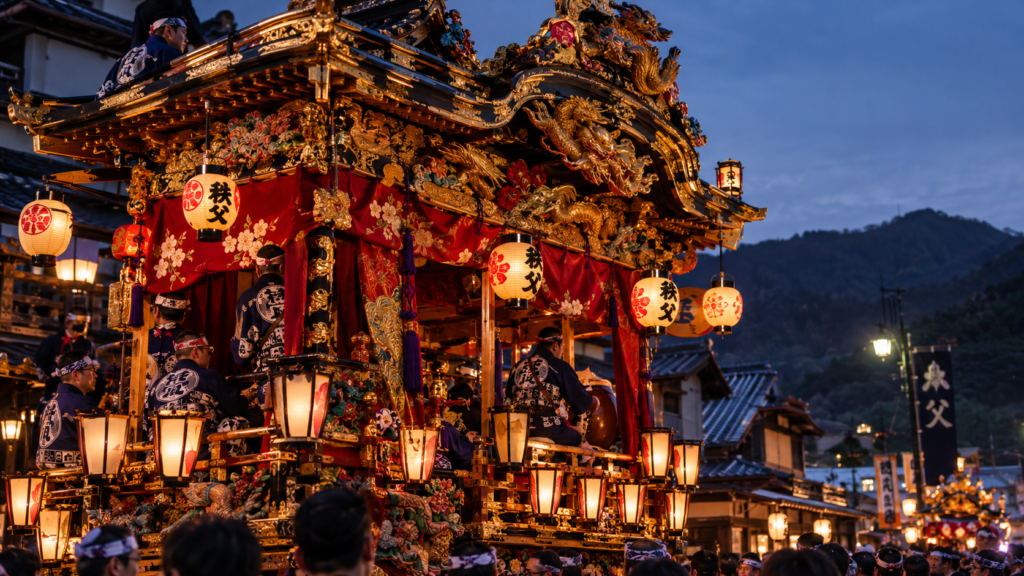 Intricate gold leaf carvings and glowing lanterns on an authentic Chichibu yatai festival float.