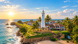 Iconic white Galle Lighthouse on green ramparts overlooking the blue Indian Ocean in Galle Fort Sri Lanka